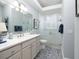 Elegant bathroom featuring patterned floors, stylish vanity, and a glass-enclosed shower at 1953 Hartford Path, The Villages, FL 32162