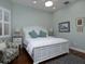 Inviting bedroom with light blue walls, hardwood floors, and a cozy seating area at 1953 Hartford Path, The Villages, FL 32162