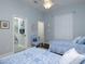 This bedroom with hardwood floors offers two beds and an attached bathroom, perfect for guests or Gathering at 1953 Hartford Path, The Villages, FL 32162