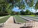 Well-maintained bocce ball courts surrounded by green space for recreational enjoyment at 1953 Hartford Path, The Villages, FL 32162