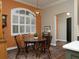 A bright breakfast nook features a round table and shuttered window for plenty of natural light at 1953 Hartford Path, The Villages, FL 32162