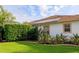 Exterior view of the home shows solar panels, a screened-in lanai, and meticulously maintained lawn at 1953 Hartford Path, The Villages, FL 32162
