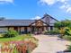 Clubhouse exterior surrounded by vibrant flowerbeds and lush landscaping at 1953 Hartford Path, The Villages, FL 32162