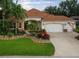 Beautiful landscaped front yard with stone walkway leads to the front door and a two-car garage at 1953 Hartford Path, The Villages, FL 32162