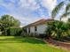 Well-maintained home exterior with a green lawn and manicured landscaping showcasing curb appeal at 1953 Hartford Path, The Villages, FL 32162