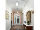 Bright foyer features hardwood floors, elegant lighting fixtures, and decorative accents that create an inviting atmosphere at 1953 Hartford Path, The Villages, FL 32162