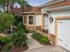Charming home exterior with manicured landscaping, stone accents, and a welcoming walkway leading to the entrance at 1953 Hartford Path, The Villages, FL 32162