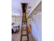 Attached garage featuring drop-down ladder for attic access and spacious parking for your car at 1953 Hartford Path, The Villages, FL 32162