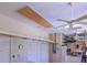 Spacious garage featuring drop down attic access ladder, storage, and ceiling fan at 1953 Hartford Path, The Villages, FL 32162