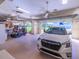 Well-organized garage with a car, golf cart, and ample space for parking and storage at 1953 Hartford Path, The Villages, FL 32162