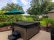 Relaxing backyard hot tub surrounded by lush landscaping, creating a private and serene outdoor space at 1953 Hartford Path, The Villages, FL 32162