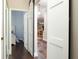 Interior hallway showcasing hardwood floors and openings to a bedroom and a living space at 1953 Hartford Path, The Villages, FL 32162
