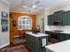 A kitchen features an island, breakfast table, stainless appliances, and white countertops at 1953 Hartford Path, The Villages, FL 32162