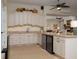 This kitchen features light colored cabinets, granite counters, and a breakfast bar at 1953 Hartford Path, The Villages, FL 32162