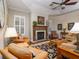 Cozy living room features a brick fireplace, built-in bookshelves, and comfortable seating, perfect for relaxation at 1953 Hartford Path, The Villages, FL 32162