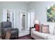 Comfortable living room with tile flooring, neutral paint, and an open view to the closets in the home at 1953 Hartford Path, The Villages, FL 32162