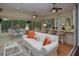 Bright Florida room with ceiling fans, comfortable seating, and views of the water fountain at 1953 Hartford Path, The Villages, FL 32162