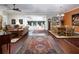 Open-concept living and dining areas with hardwood floors, and access to a serene sunroom with lots of light at 1953 Hartford Path, The Villages, FL 32162