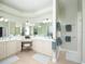 Bright bathroom boasts a vanity with double sinks, ample counter space, and a large mirror for added convenience at 1953 Hartford Path, The Villages, FL 32162