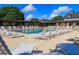 Inviting community pool area with plenty of lounge chairs, perfect for relaxing at 1953 Hartford Path, The Villages, FL 32162