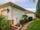 Well-maintained side yard with stone accents and lush landscaping along the exterior of the home at 1953 Hartford Path, The Villages, FL 32162