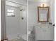 Dual view of updated bathroom featuring tiled shower, brushed gold hardware and updated vanity at 21191 Sw Plantation St, Dunnellon, FL 34431