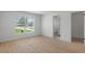 Spacious bedroom featuring wood-look floors, and a window view to the front yard at 21191 Sw Plantation St, Dunnellon, FL 34431