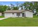 Charming single-story home features a welcoming facade, attached garage and a well-manicured lawn at 21191 Sw Plantation St, Dunnellon, FL 34431