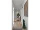 Bright hallway with wood floors leads to a cozy living area featuring recessed lighting at 21191 Sw Plantation St, Dunnellon, FL 34431