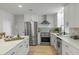 Modern kitchen features stainless steel appliances, quartz countertops, and shaker-style cabinets at 21191 Sw Plantation St, Dunnellon, FL 34431