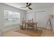Bright office features a wooden desk, window with blinds and ceiling fan at 21191 Sw Plantation St, Dunnellon, FL 34431