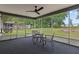 Relaxing screened patio with table and chairs, perfect for enjoying the outdoors at 21191 Sw Plantation St, Dunnellon, FL 34431