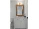 Updated bathroom vanity with marble countertop, white cabinet and brushed gold hardware at 21191 Sw Plantation St, Dunnellon, FL 34431