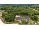 An aerial view shows the house with lush greenery and expansive land at 2297 Sw 143 Ct, Ocala, FL 34481