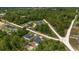 An aerial view showcases the home nestled among lush greenery and expansive land at 2297 Sw 143 Ct, Ocala, FL 34481