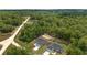An aerial view showcases the home nestled among lush greenery and expansive land at 2297 Sw 143 Ct, Ocala, FL 34481