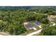 An aerial view showcases the home nestled among lush greenery and expansive land at 2297 Sw 143 Ct, Ocala, FL 34481
