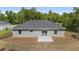 Aerial view of backyard, with sliding glass doors and patio at 2297 Sw 143 Ct, Ocala, FL 34481