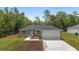 Charming single-story home boasts a two-car garage and simple landscaping at 2297 Sw 143 Ct, Ocala, FL 34481
