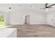 Open living space with wood-look floors leads to a bathroom with tiled tub at 2297 Sw 143 Ct, Ocala, FL 34481