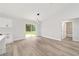 Open living area features wood-look floors and sliding glass door to backyard at 2297 Sw 143 Ct, Ocala, FL 34481