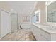 Elegant bathroom with glass enclosed shower, soaking tub, and a double sink vanity at 2640 Sw 36Th Ln, Ocala, FL 34471
