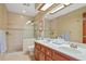 Bathroom featuring tiled shower, and double sinks with a large mirror at 2640 Sw 36Th Ln, Ocala, FL 34471