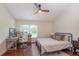 Comfortable bedroom featuring a ceiling fan and a desk next to a window for a work area at 2640 Sw 36Th Ln, Ocala, FL 34471