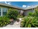Lush landscaping featuring gravel beds, potted plants, and tropical foliage at 2640 Sw 36Th Ln, Ocala, FL 34471