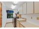 Functional laundry room with a washer and dryer, ample counter space, a sink, and plenty of storage at 2640 Sw 36Th Ln, Ocala, FL 34471