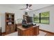 Bright home office with hardwood floors, large window, bookshelves and ceiling fan at 2640 Sw 36Th Ln, Ocala, FL 34471