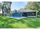 Expansive backyard featuring a blue house, lush lawn and inviting pool at 2855 Se 38Th St, Ocala, FL 34480