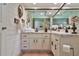 Bright bathroom with white cabinets, granite countertops, and decorative accents and a large mirror at 2855 Se 38Th St, Ocala, FL 34480