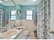 Charming bathroom with vanity, decorative mirror, and shower-tub combo at 2855 Se 38Th St, Ocala, FL 34480